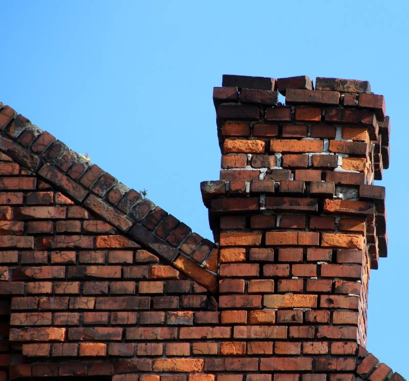 Damaged chimney on an Prosper home showing cracks and missing mortar